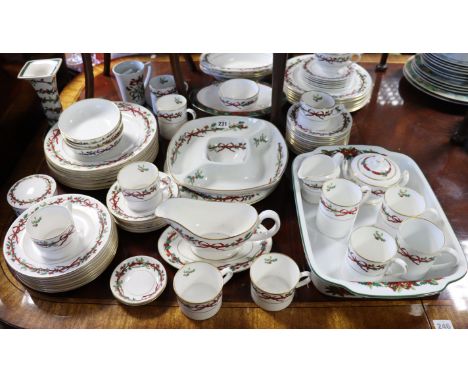 A Royal Worcester bone china “Holly Ribbons” extensive eight-one piece dinner, tea, &amp; coffee service. 