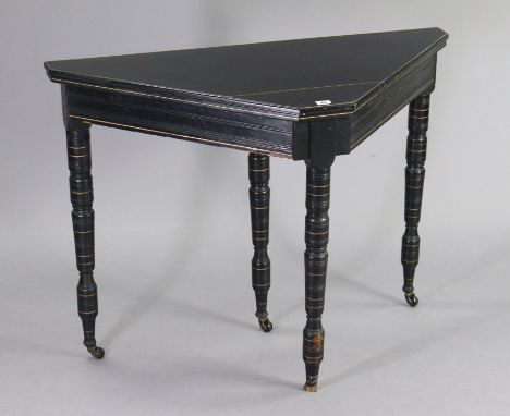 A late Victorian aesthetic-style ebonised &amp; gilt card table inset green baize to the fold-over&nbsp;top, on four ring-tur