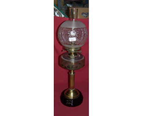 A table Oil Lamp with etched glass shade, the glass reservoir with painted decoration on a reeded brass column and circular f