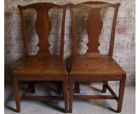 A pair of Georgian oak country Dining Chairs with solid splat backs, panel seats and square tapering supports.