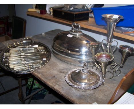 A plated oval Meat Cover engraved with a crest, plated oval tray, a four branch Epergne and other items.