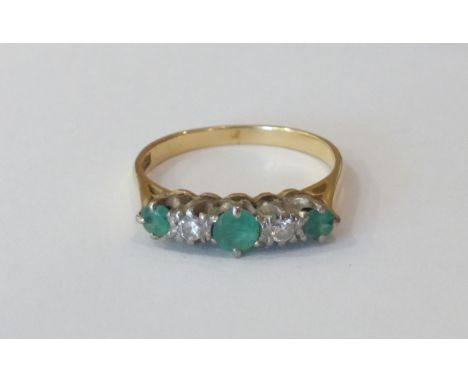 A gold five stone emerald and diamond Ring, marked '18ct.'