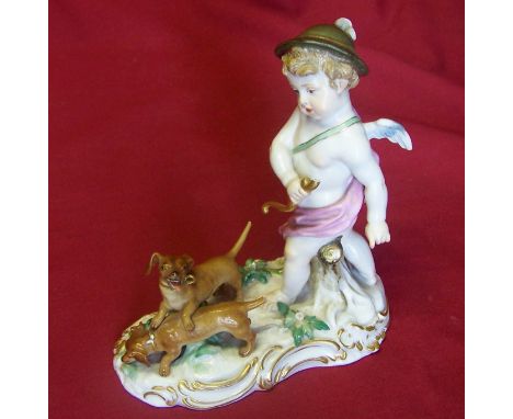 A Meissen group of Cupid hunting with two dogs on a Rococo style base, no. Q182.  6" (15cms)  (with losses).