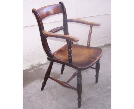 A 19th century oak and elm "Trafalgar" style Elbow Chair with rope twist back, panel seat and turned supports.