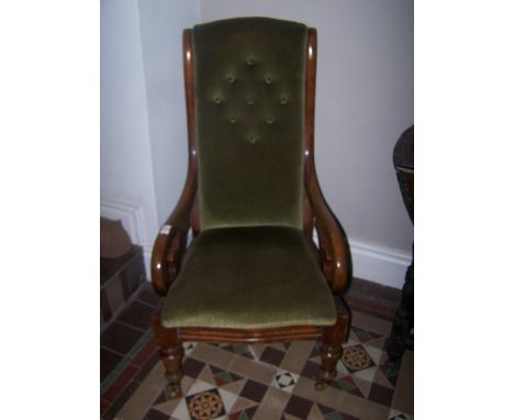A Victorian mahogany open Armchair with button upholstered seat and back, scroll arms and turned supports.  