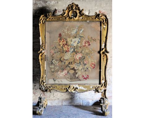 #  A mid 18th Century gilt wood Fire Screen, the shaped cresting rail painted with the arms of Strickland, and inset with a f