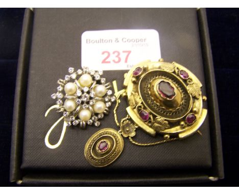 A Victorian oval Brooch set with purple stone and a silver and pearl brooch.