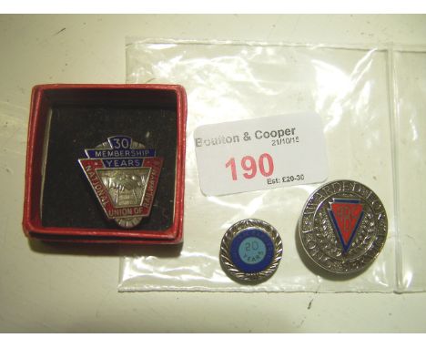 A silver and enamel NUR Badge and two others.