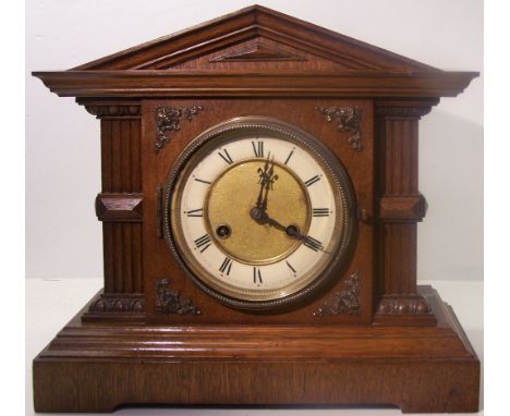 An early 20th century Mantle Clock with German movement by Junghans, ivorine and brass dial, in architectural style oak case,