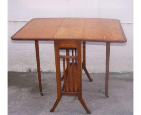 An Edwardian oak Sutherland Tea Table with mahogany cross banding and chevron inlay, with 'D' shape drop leaves, on pierced p