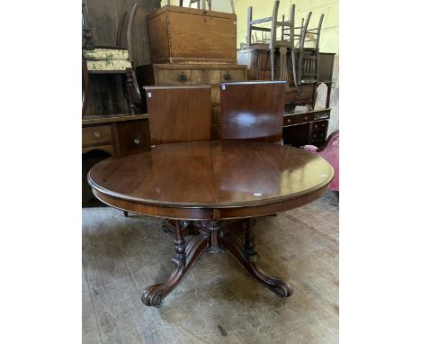 A 19th century mahogany oval extending dining table, raised on a turned column base, 137 cm wide, with two extra 49 cm leaves