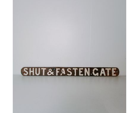 A painted cast iron sign, Shut &amp; Fasten Gate, 85 cm wide