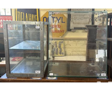 A vintage table top glass display cabinet, with an enamel base, 60 cm wide, three other table top display cabinets and a box 