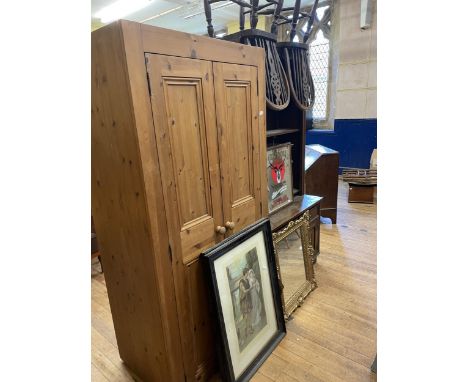 A pine wardrobe, an oak bookcase, a pine dining table, three chairs, seven tea chests, a pair of lamp bases, assorted other i