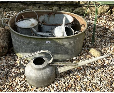 Three metal watering cans, a metal planter and a tin bath (5)