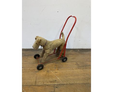 A vintage push along dog