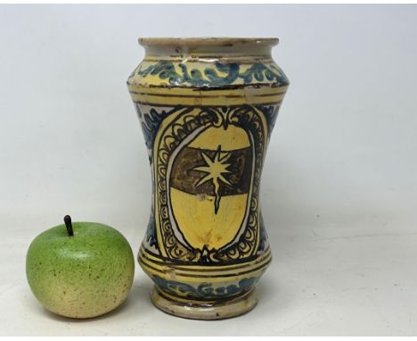 An 18th century provincial albarello, probably Southern Italy, decorated foliate forms, 21 cm high