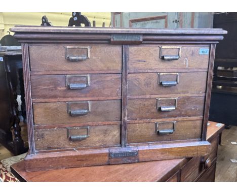 An unusual Canadian walnut filing cabinet, having eight drawers, with brass plaque reading Hart &amp; Company Toronto, 79 cm 