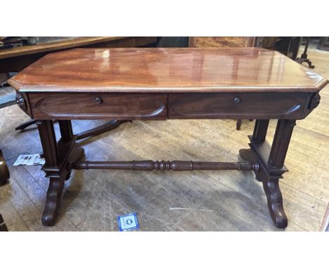 A mahogany Gothic Revival library table, having two frieze drawers, on carved twin end supports, 123 cm wide