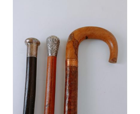 An Indian silver mounted walking stick, and two other walking sticks (3)