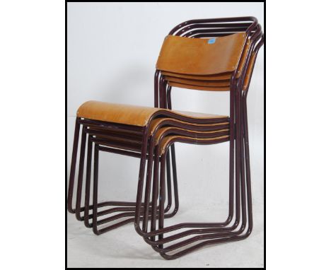 A set of four vintage mid 20th century church / village hall stacking chairs. With Burgundy tubular frames having panel seats