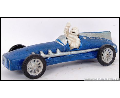 A vintage style, advertising cast iron blue racing car being driven by the Michelin Man. 28cm long. 