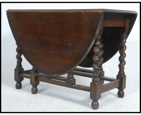 A good solid barleytwist country oak drop leaf dining table of large proportions having gate leg action. Measures: 74cms high