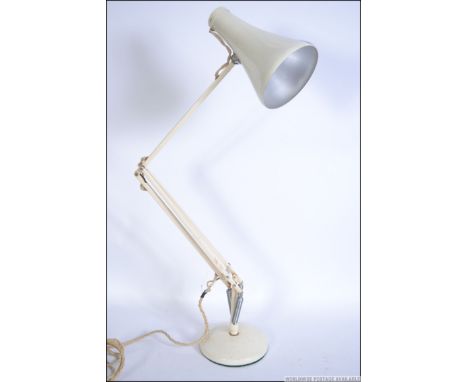 A 20th century retro Herbert Terry Anglepoise lamp in white raised on a circular base with pendant shade