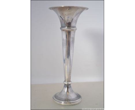 A silver hallmarked trumpet solifleur vase having engine turned rim by Broadway and Co, Birmingham 1981.  Weight 68.5g. Measu