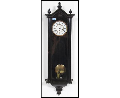 An early 20th century large ebonised mahogany vienna regulator wall clock having enamel dial with roman numeral chapter ring 