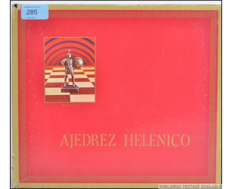 An Ajedrez Helenico cold painted bronze spelter chess set complete in the original box