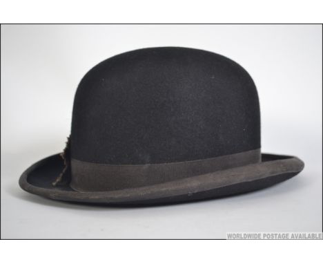 A vintage early 20th century  bowler hat by Hawkes & Co of Savile Row London with a silk lining with a leather head band. Mad