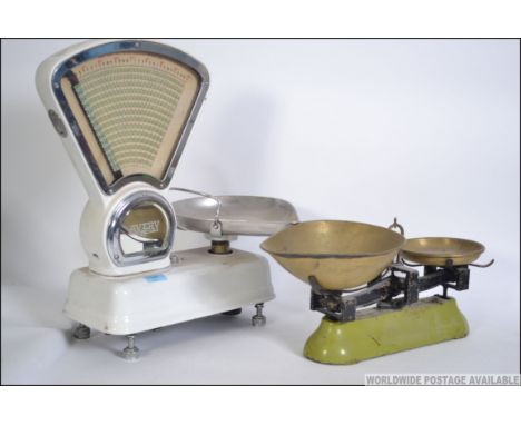 A pair of vintage  white enamel Avery Grocer's shop scales along with a pair of vintage Avery balance scales. The tallest mea