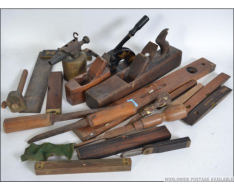 A collection of vintage woodworking tools to include several levels, box plane, chisels etc please see images