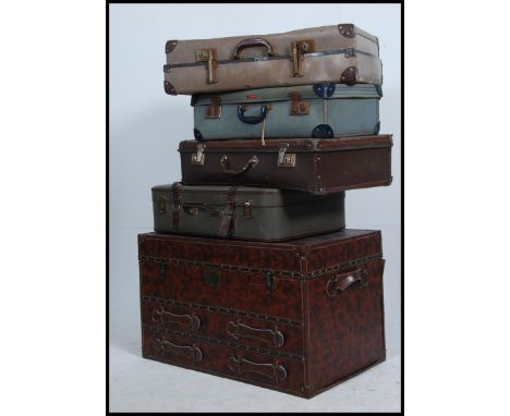 A stack of vintage suitcases and trunks etc to include mid century and early 20th century together with a leather effect trun