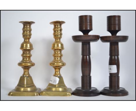 A pair of Victorian brass , lead weighted candlesticks with square bases along with a pair of engine turned mid century hardw