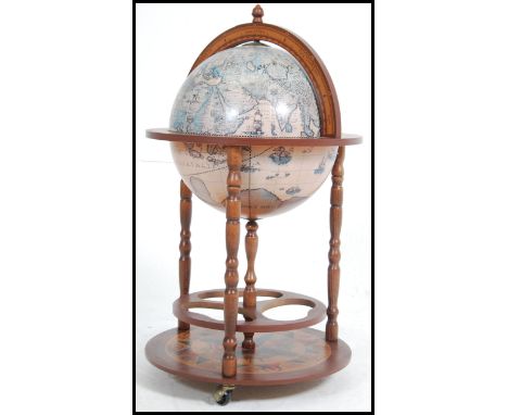 A 20th century antique style globe cocktail / drinks cabinet. The hinged glove with appointed interior raised on bobbin suppo