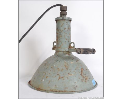 A vintage industrial 20th century metal cased Maxlume hand held spot lamp with a wooden handle and thick glass front. Measure