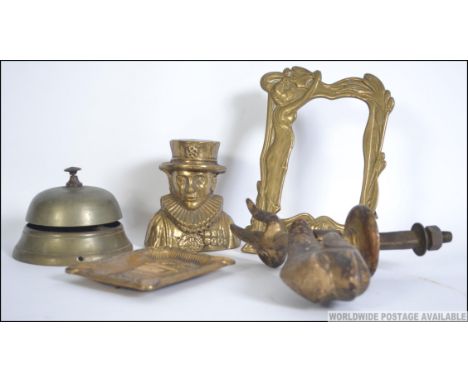 A collection of brasswares to include a Beefeater money box, a Waterloo ashtray, a large heavy Carp door knocker,  a counter 