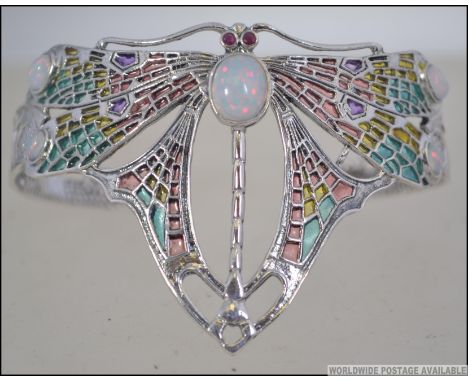A silver plique a jour ladies Art Nouveau bangle in the form of a dragonfly. Measures 7cms diam to the arm. Weight 24.7g