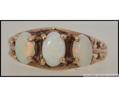 A 10ct gold and opal ring, the 3 cabochon opals being claw mounted. , inside shank marked 10k dynasty. Size P / Weight 2.6g