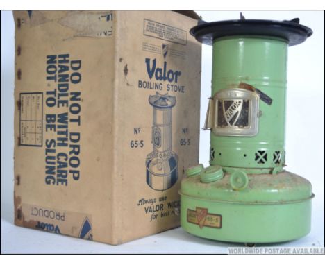 A vintage enamel Valor boiler stove dating from the mid 20th century, retaining it's original cardboard box with advertising 