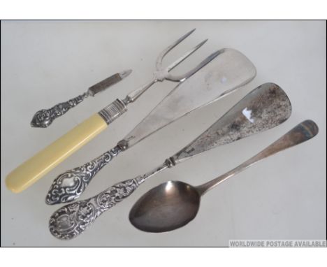 A collection of silver items to include rococo silver handled shoe horns, toasting fork, nail file and a silver hallmarked de