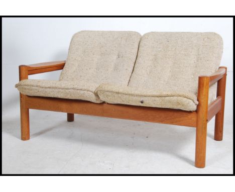 A retro 20th century Danish teak framed two seater sofa with drop oatmeal fabric seats by Domino.