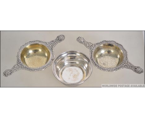 A pair of vintage silver plated Prima NS tea strainers, being marked to the underside together with one tray dish. Measures 1