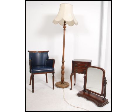 A Regency style mahogany and faux blue leather library armchair raised on reeded legs together with a standard lamp and shade