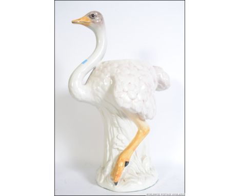 A vintage retro 20th century kitsch Staffordshire type Ostrich / Emu ceramic stick stand - planter set upon a naturalistic pl