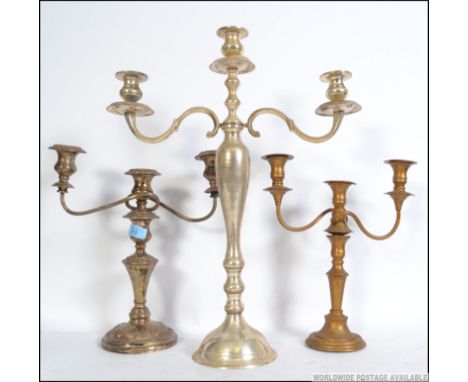 A collection of silver plated candelabra to include a large 3 sconce example measuring 56cms high along with 2 others Tallest