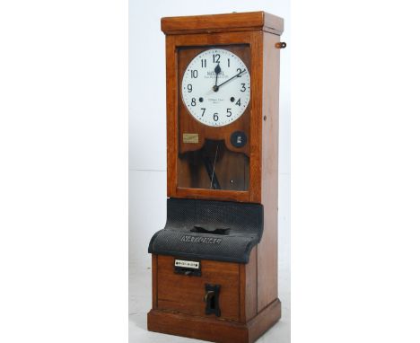 An early 20th century wall mounted mahogany cased National Time Recorder with circular dial set with Roman numerals, subsidia