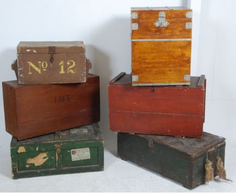 A collection of wooden trunks and chests to include an ammunition crate in green, army crate with rope handles, wooden army b